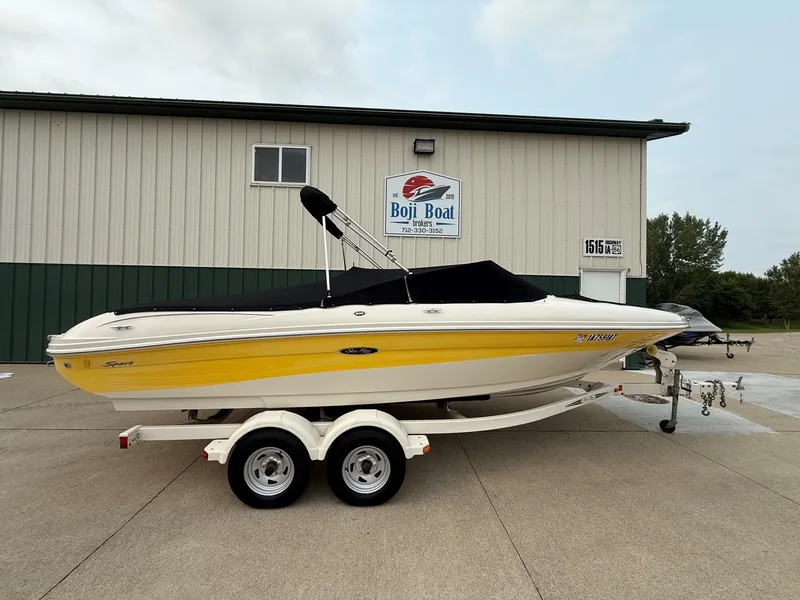 Slide: The Image of 2005 Sea Ray 200 Sport on a trailer in front of a building. - 24