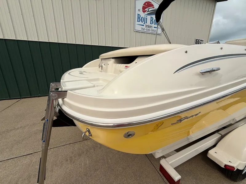 Slide: The Image of Rear view of a 2005 Sea Ray 200 Sport boat with a yellow hull on a trailer. - 6