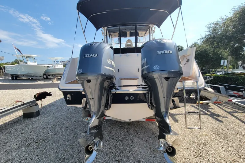 Slide: The Image of 2005 Grady-White Express 330 boat with twin Yamaha 300 engines, docked outdoors. - 10