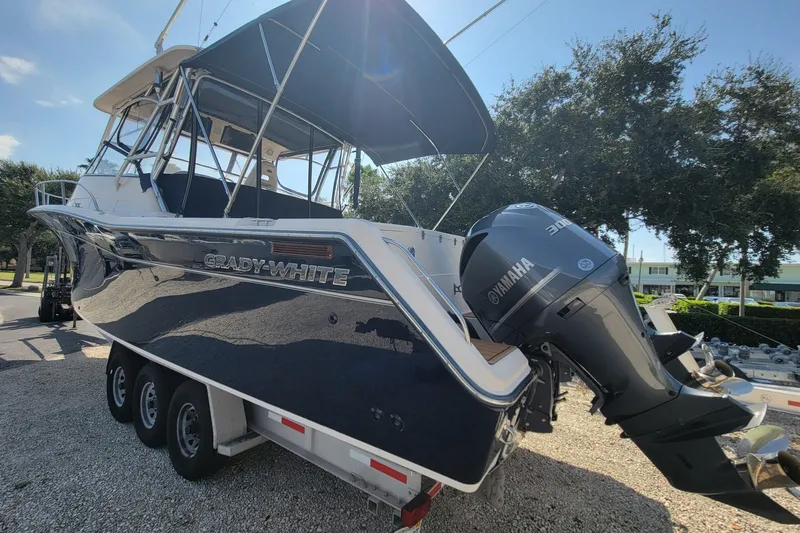 Slide: The Image of 2005 Grady-White Express 330 boat with Yamaha outboard motor, parked on a trailer. - 4