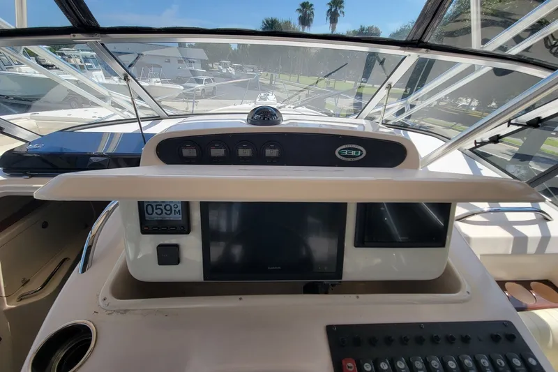 Slide: The Image of 2005 Grady-White Express 330 boat dashboard with navigation instruments and controls. - 27