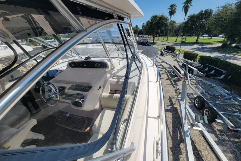 Slide: The Image of 2005 Grady-White Express 330 boat interior with steering wheel, parked on trailer. - 16