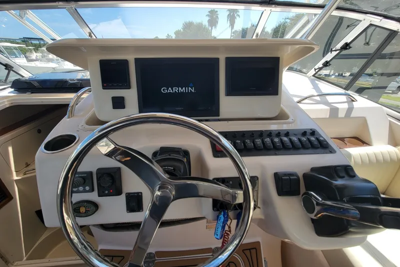 Slide: The Image of 2005 Grady-White Express 330 helm with Garmin navigation system and steering wheel. - 25