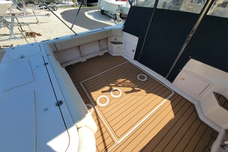 Slide: The Image of 2005 Grady-White Express 330 boat interior with teak flooring and cushioned seating. - 7