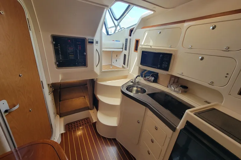 Slide: The Image of 2005 Grady-White Express 330 cabin interior with kitchenette and control panel. - 24