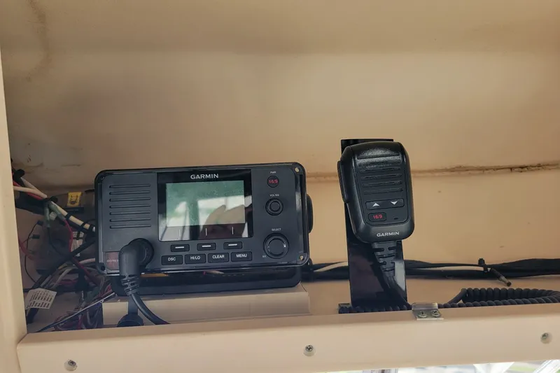 Slide: The Image of Garmin marine radio and microphone on 2005 Grady-White Express 330 boat dashboard. - 26