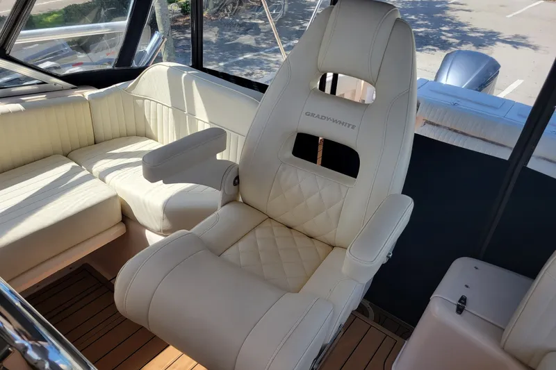 Slide: The Image of Luxurious seating on a 2005 Grady-White Express 330 boat, featuring plush white upholstery. - 28