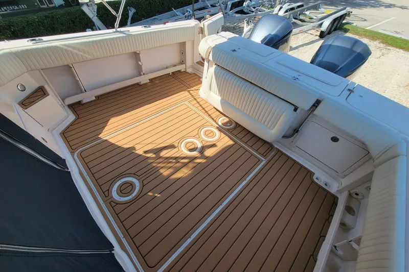 Slide: The Image of 2005 Grady-White Express 330 boat deck with teak flooring and cushioned seating. - 8