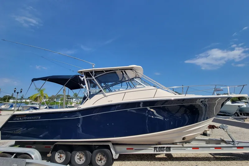 Slide: The Image of 2005 Grady-White Express 330 boat on trailer under clear blue sky. - 1