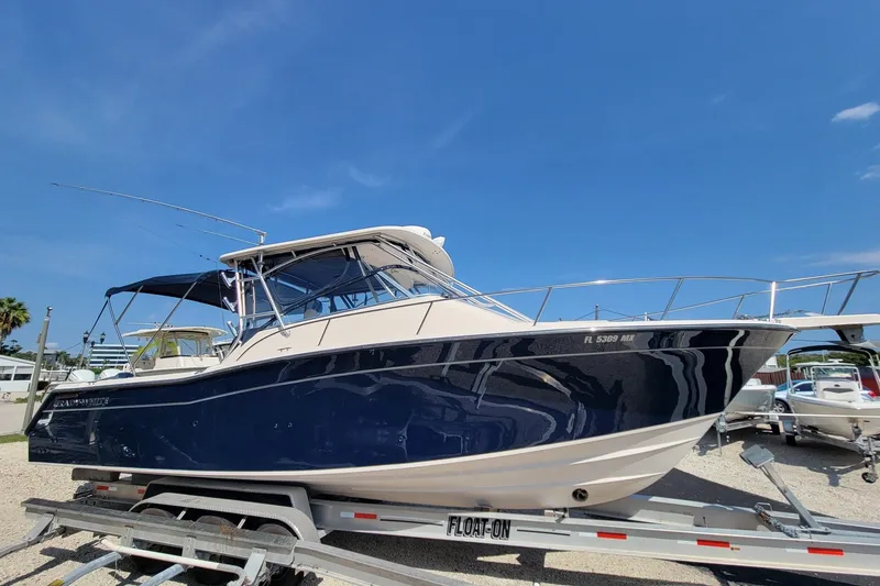 Slide: The Image of 2005 Grady-White Express 330 boat on trailer under clear blue sky. - 3