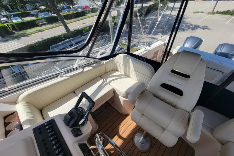 Slide: The Image of 2005 Grady-White Express 330 boat interior with beige seating and helm station. - 18
