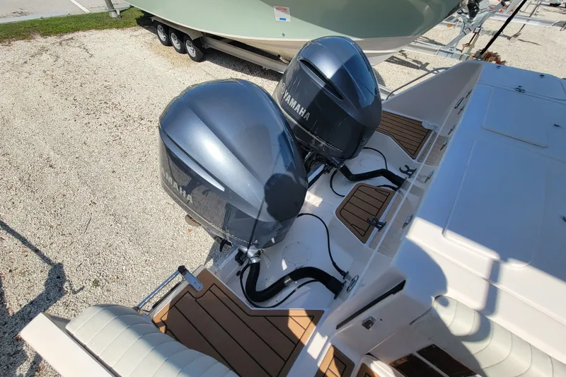 Slide: The Image of 2005 Grady-White Express 330 with twin Yamaha outboard engines, docked on gravel. - 6