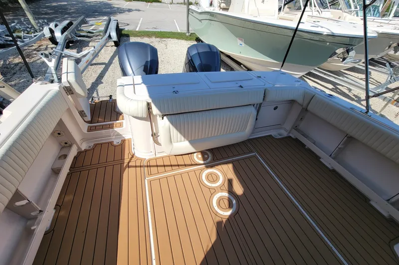 Slide: The Image of 2005 Grady-White Express 330 boat deck with twin engines and teak flooring. - 9