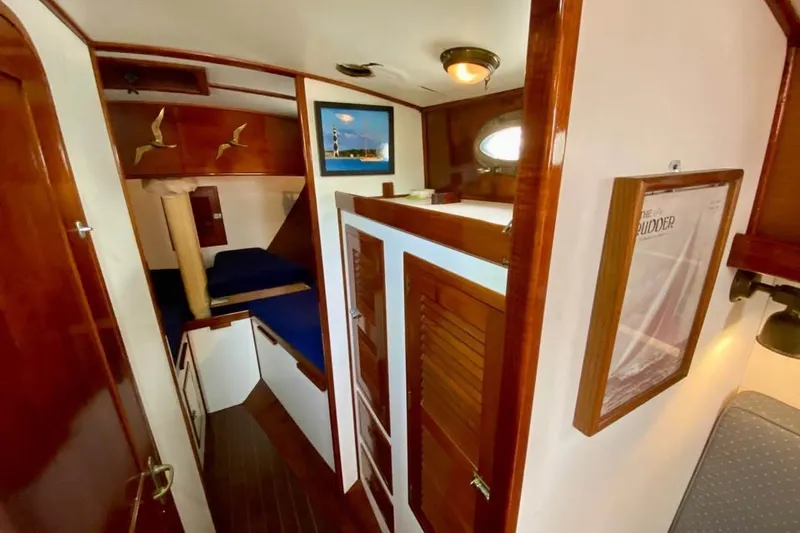Slide: The Image of Interior of 1985 Nereia Yachts 38, featuring wooden cabinetry and cozy sleeping quarters. - 12