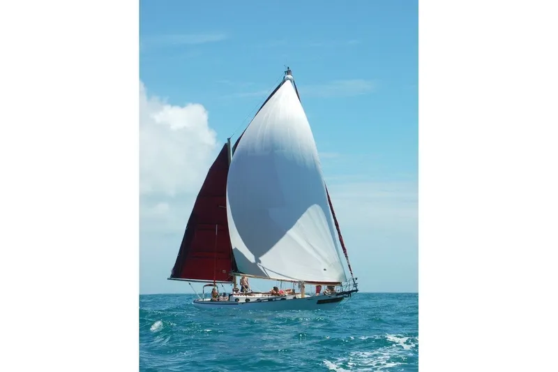 Slide: The Image of Sailing yacht Nereia 38 from 1985 on open sea under clear blue sky. - 4