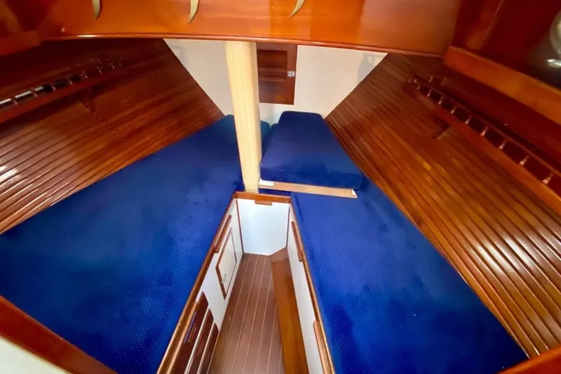 Slide: The Image of Interior cabin of 1985 Nereia Yachts 38 with blue upholstery and wooden finish. - 14