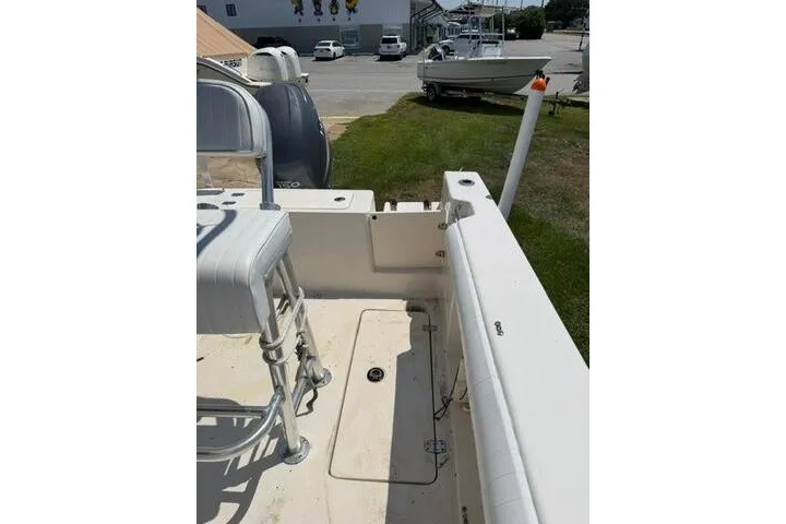 Slide: The Image of 2010 Cobia 216 Center Console boat interior with seating and storage compartments. - 18