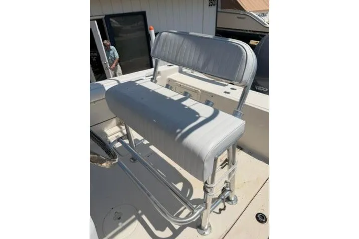 Slide: The Image of 2010 Cobia 216 Center Console boat seat with white upholstery and metal frame. - 19