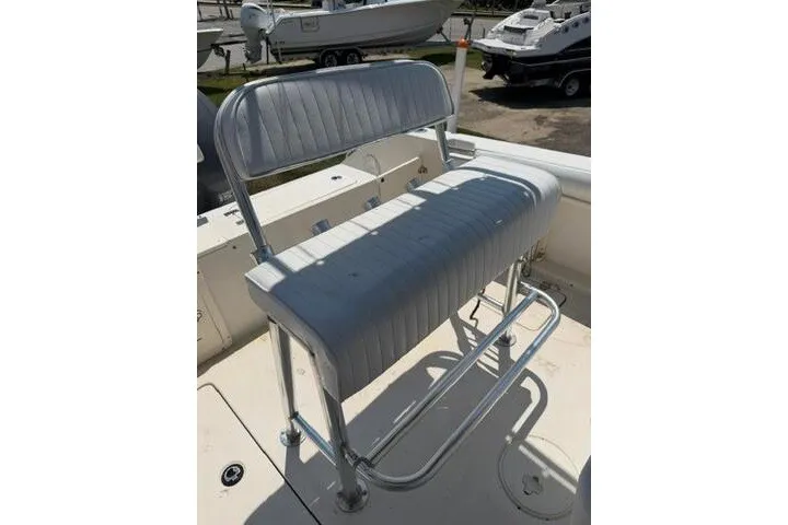 Slide: The Image of 2010 Cobia 216 Center Console boat seat with metal frame and cushioned backrest. - 17