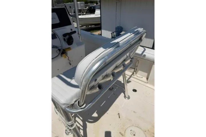 Slide: The Image of 2010 Cobia 216 Center Console boat interior with seating and steering console. - 22