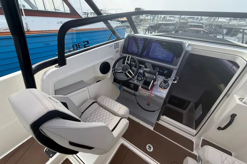 Slide: The Image of Modern Navan S30 boat cockpit with advanced controls and dual screens, 2025 model. - 12