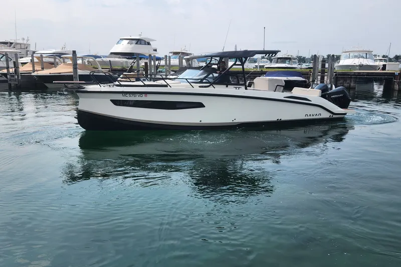 Slide: The Image of 2025 Navan S30 boat docked in a marina, featuring sleek design and modern amenities. - 4