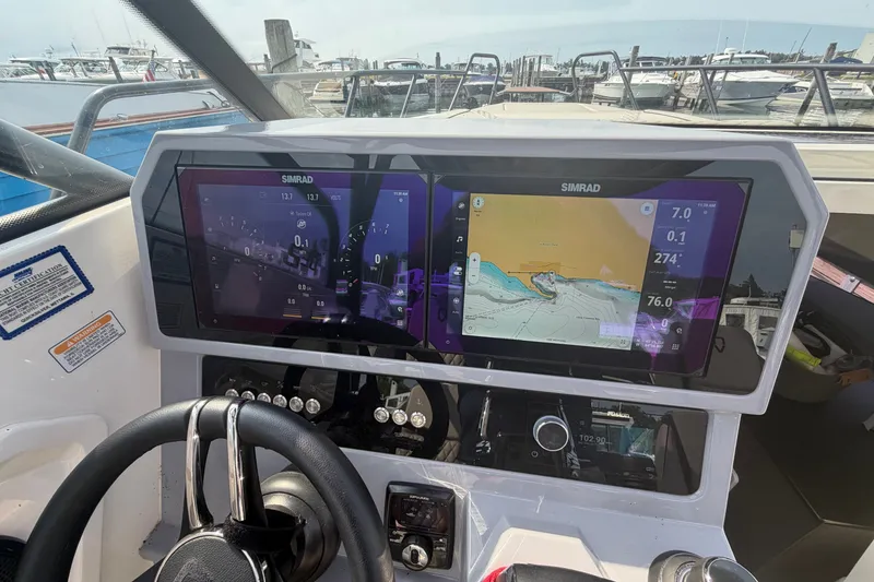 Slide: The Image of Dashboard of 2025 Navan S30 boat with Simrad navigation system at marina. - 18
