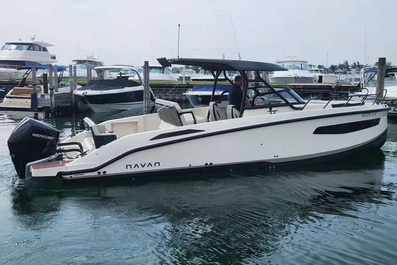 The Image of 2025 Navan S30 boat docked, featuring sleek design and Mercury outboard engine. - 1