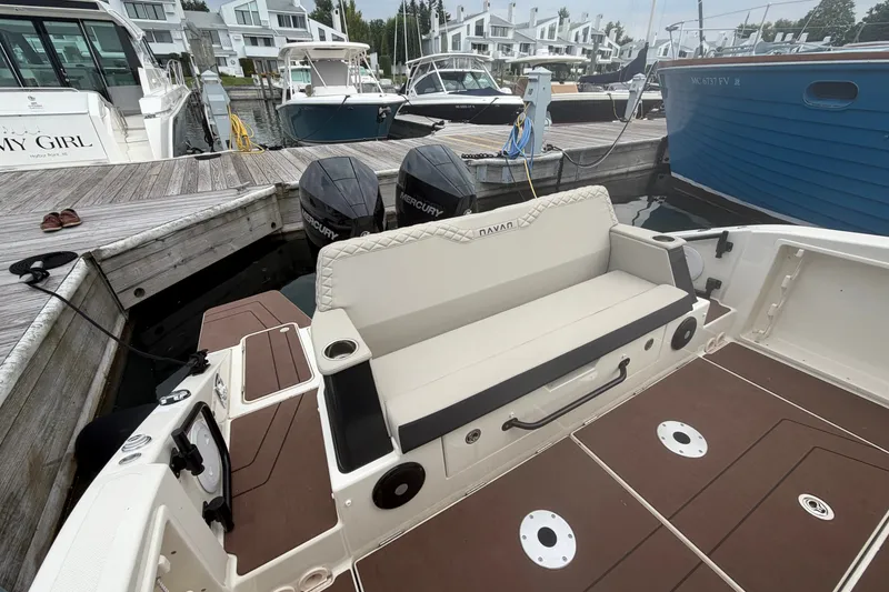 Slide: The Image of 2025 Navan S30 boat docked, featuring dual Mercury engines and a spacious seating area. - 7