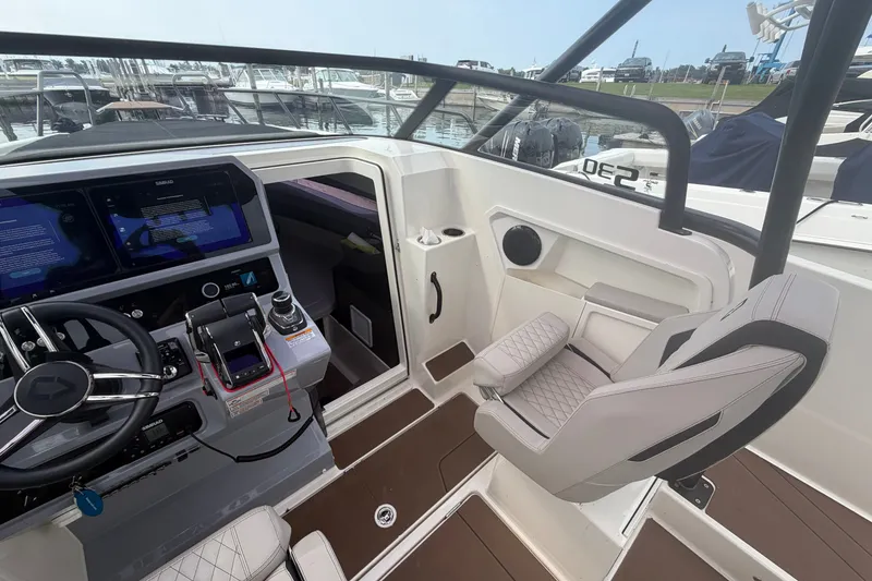 Slide: The Image of Interior of 2025 Navan S30 boat with modern dashboard and seating at marina. - 13