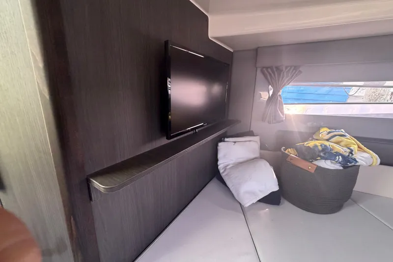 Slide: The Image of Interior of 2025 Navan S30 with TV, cozy bedding, and window view. - 25