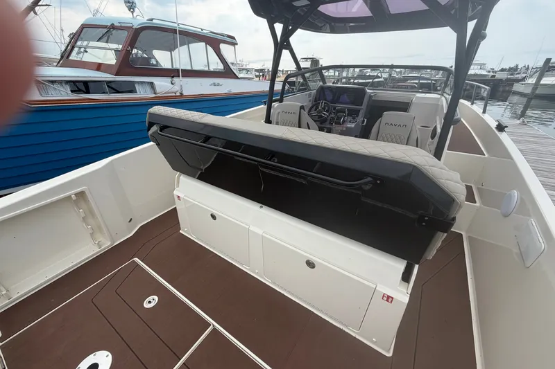 Slide: The Image of 2025 Navan S30 boat interior with modern seating and control panel at a marina. - 8