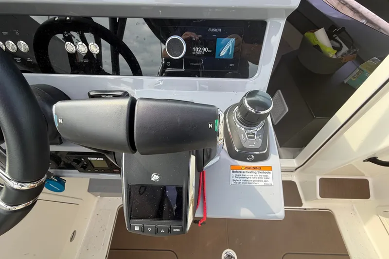 Slide: The Image of Control panel of 2025 Navan S30 boat with steering wheel and navigation controls. - 19