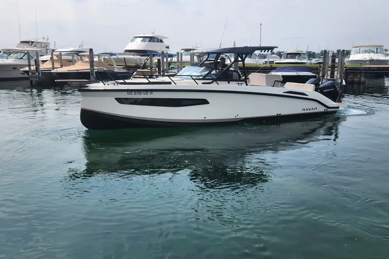 Slide: The Image of 2025 Navan S30 boat docked in marina, surrounded by other vessels. - 5