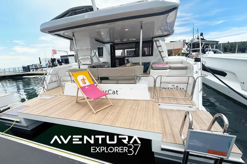 Slide: The Image of Aventura 37 Explorer Trawler 2026, docked with spacious deck and seating area. - 33