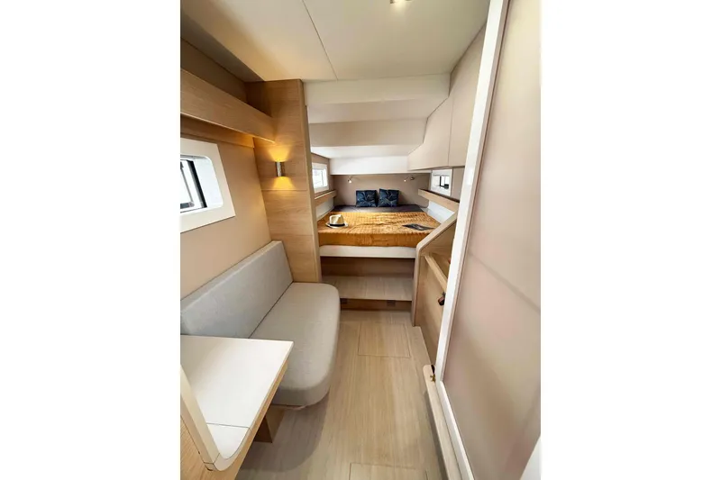 Slide: The Image of Interior of 2026 Aventura 37 Explorer Trawler, featuring cozy cabin with bed and seating area. - 7