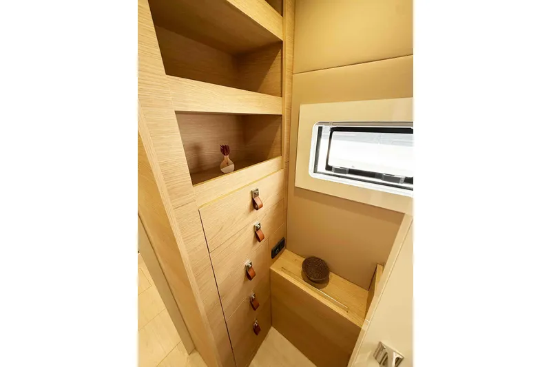 Slide: The Image of Interior of 2026 Aventura 37 Explorer Trawler with wooden shelves and window. - 16