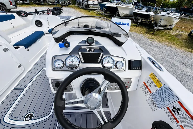 Slide: The Image of Cockpit view of 2022 Tahoe 2150 boat with steering wheel and control panel. - 30