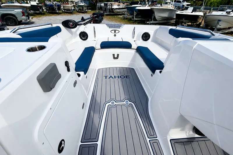 Slide: The Image of 2022 Tahoe 2150 boat interior with blue seating and sleek design. - 29