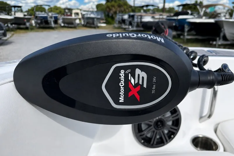 Slide: The Image of MotorGuide X3 trolling motor on 2022 Tahoe 2150 boat, with other boats in background. - 19