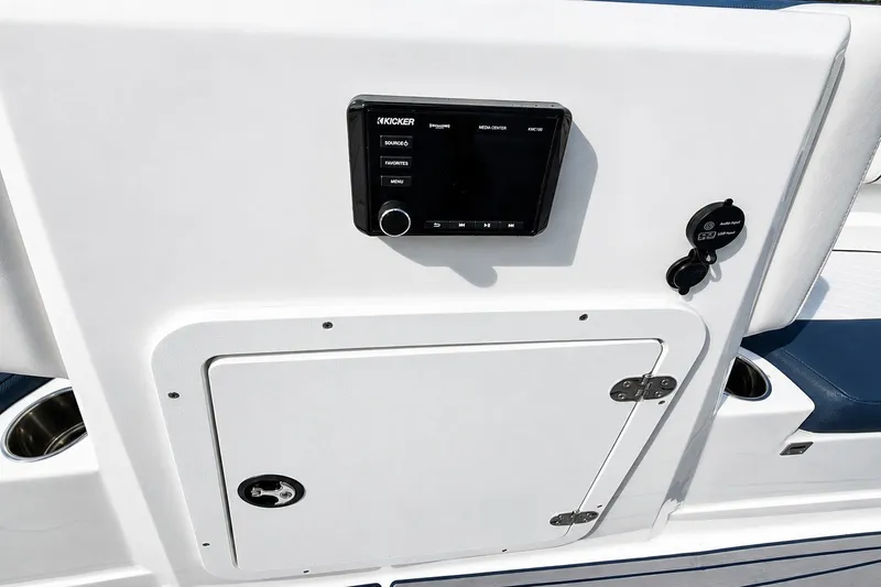 Slide: The Image of 2022 Tahoe 2150 boat dashboard with Kicker media center and storage compartment. - 23