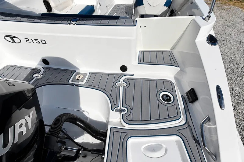 Slide: The Image of 2022 Tahoe 2150 boat deck with sleek design and Mercury engine. - 36