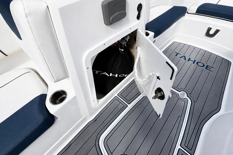 Slide: The Image of 2022 Tahoe 2150 boat interior with open storage compartment and branded flooring. - 21