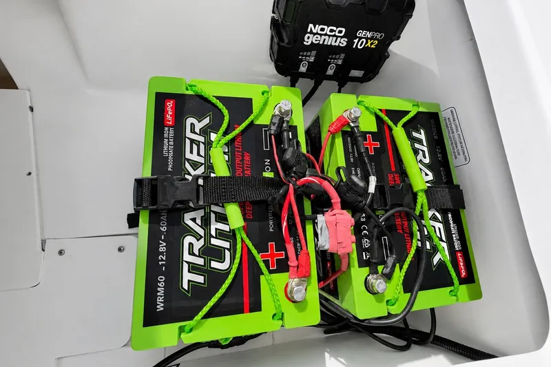Slide: The Image of Dual Tracker lithium batteries in a 2022 Tahoe 2150 boat with Noco Genius charger. - 45