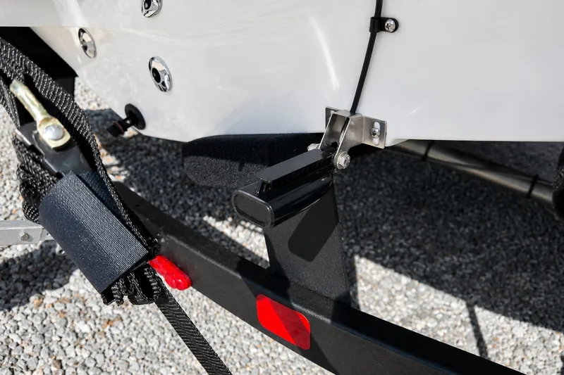Slide: The Image of Close-up of 2022 Tahoe 2150 boat trailer hitch and strap on gravel. - 39