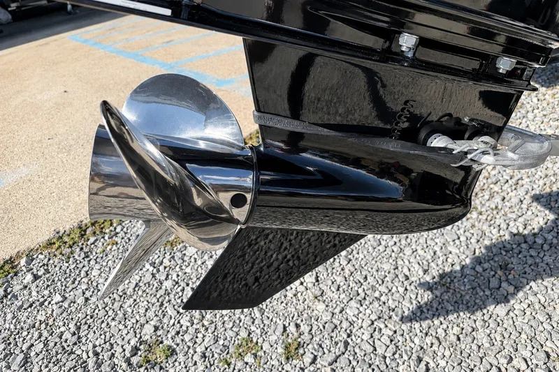 Slide: The Image of 2022 Tahoe 2150 boat propeller, shiny metal finish, on gravel surface. - 44