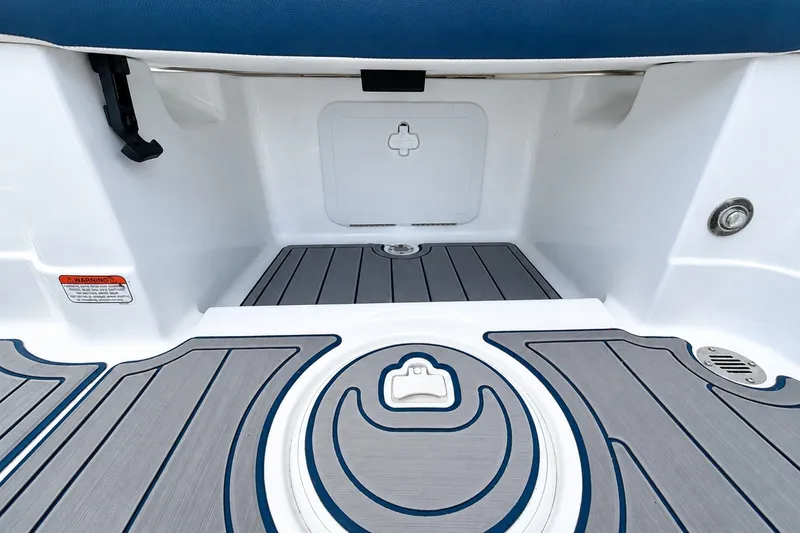 Slide: The Image of 2022 Tahoe 2150 boat interior with non-slip flooring and storage compartment. - 16