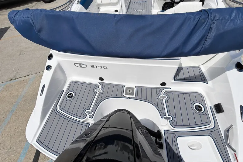 Slide: The Image of 2022 Tahoe 2150 boat with blue seating and sleek deck design. - 34