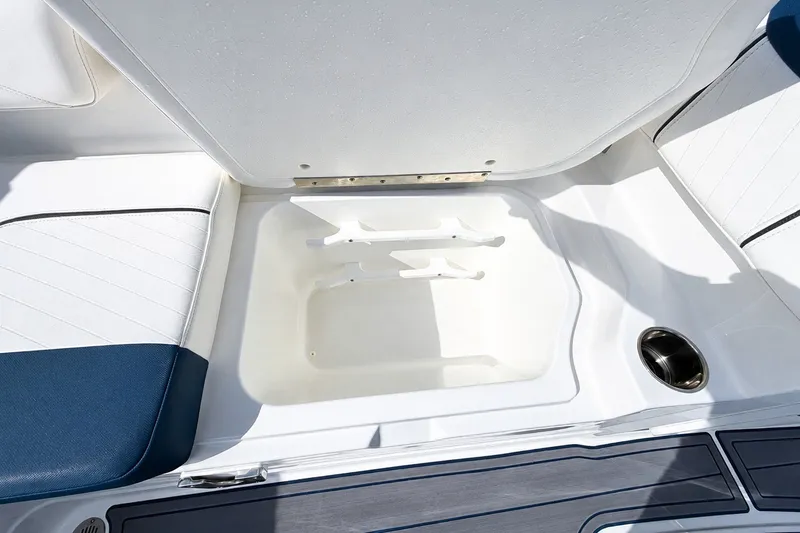 Slide: The Image of 2022 Tahoe 2150 boat storage compartment with white and blue seating. - 14