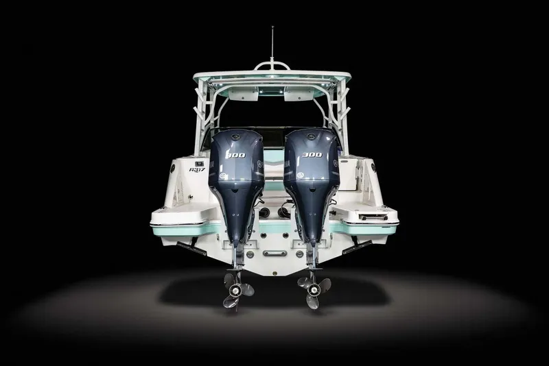 Slide: The Image of Manufacturer Provided Image: 2025 Robalo R317 Dual Console boat with twin 300 horsepower engines, rear view. - 23